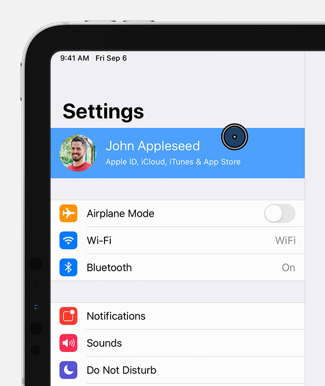 An iPad on the Settings screen with the pointer selecting John Appleseed's account.